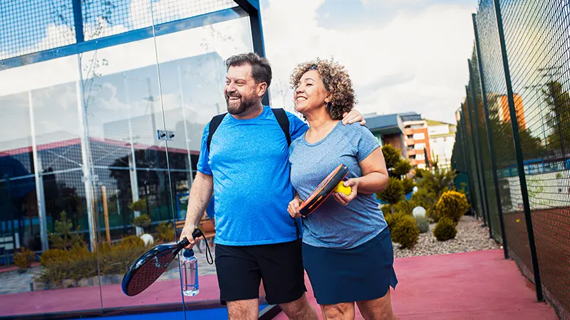 couple with pickleball rackets